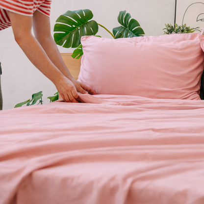 Mani che reggono rosa bambù fabric, highlighting its lightweight, silky texture.