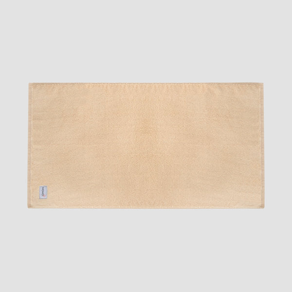 Tappeto bagno beige in bambù Momo Cotton – morbido, assorbente, asciugatura rapida e sostenibile.